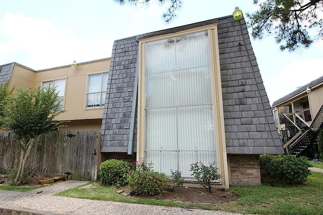 view of outbuilding featuring fence