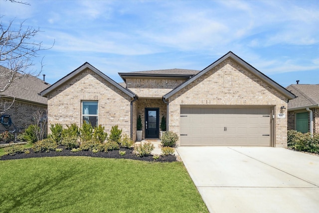 view of front of home with brick siding, a garage, driveway, and a front lawn