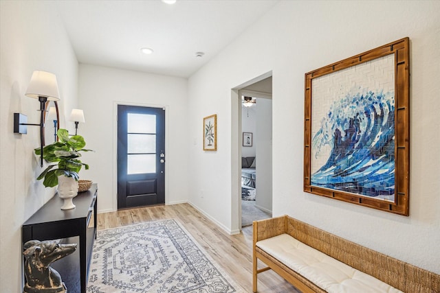 entrance foyer featuring light wood-style flooring and baseboards