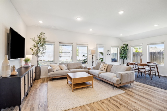 living area featuring lofted ceiling, recessed lighting, and light wood finished floors