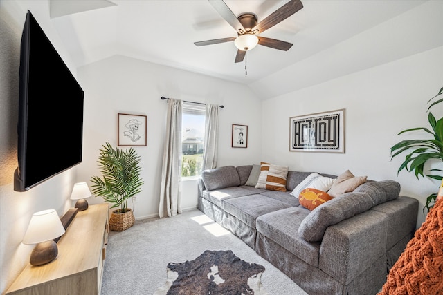 living area featuring lofted ceiling, carpet flooring, a ceiling fan, and baseboards