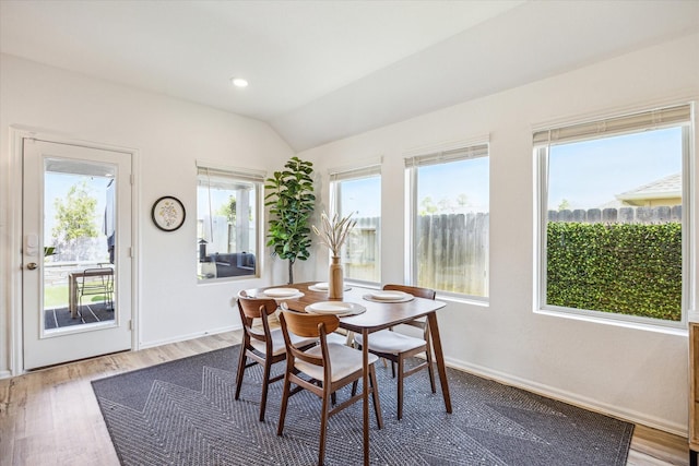 dining room with recessed lighting, baseboards, lofted ceiling, and wood finished floors