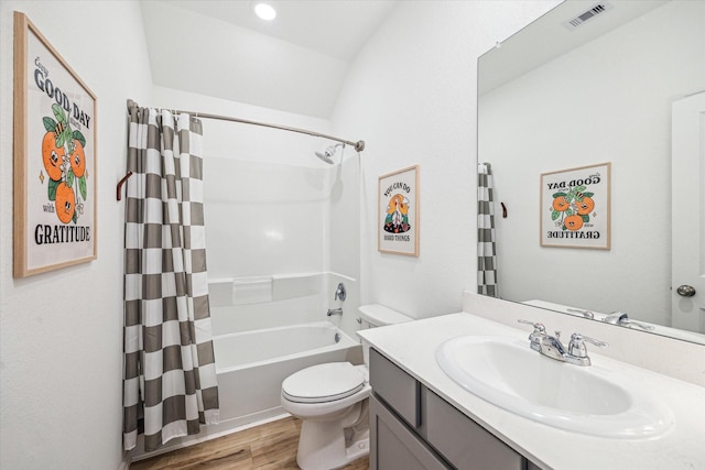 bathroom featuring vanity, shower / bathtub combination with curtain, wood finished floors, visible vents, and toilet