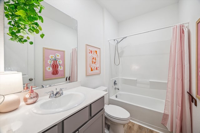 full bath featuring vanity, toilet, wood finished floors, and shower / tub combo with curtain