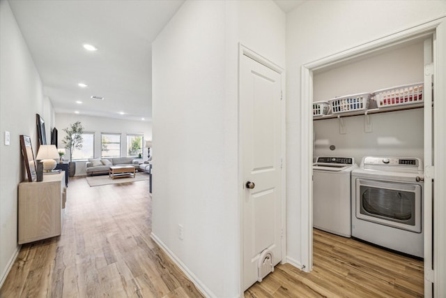 laundry room with washer and dryer, recessed lighting, light wood finished floors, baseboards, and laundry area