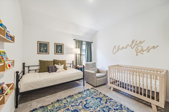 carpeted bedroom with lofted ceiling