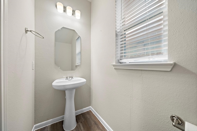 bathroom featuring baseboards and wood finished floors