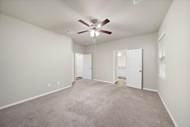 unfurnished bedroom with visible vents, baseboards, ensuite bathroom, and carpet