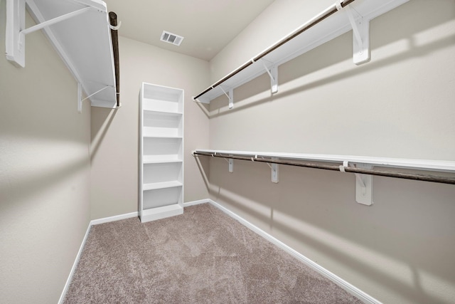 walk in closet with visible vents and carpet floors