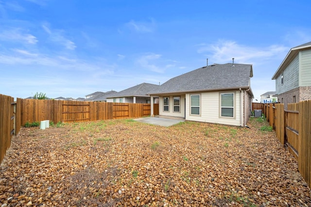 rear view of house with a patio, cooling unit, and a fenced backyard