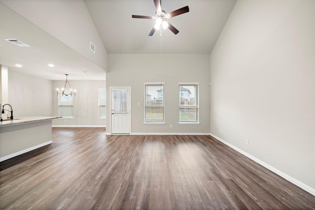 unfurnished living room featuring a sink, visible vents, dark wood-type flooring, and ceiling fan with notable chandelier