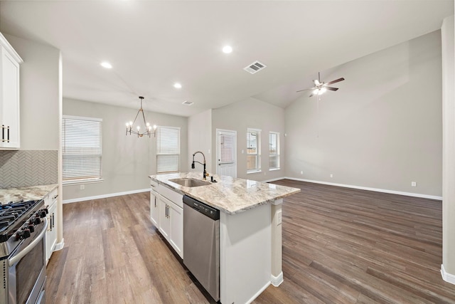 kitchen with visible vents, white cabinets, stainless steel appliances, and a sink