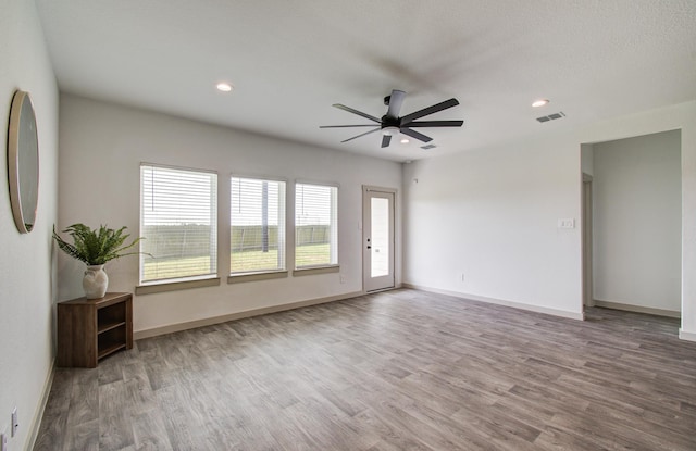 unfurnished room featuring recessed lighting, baseboards, wood finished floors, and ceiling fan