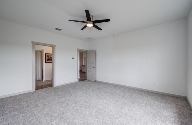 unfurnished bedroom with visible vents, carpet flooring, a ceiling fan, and baseboards