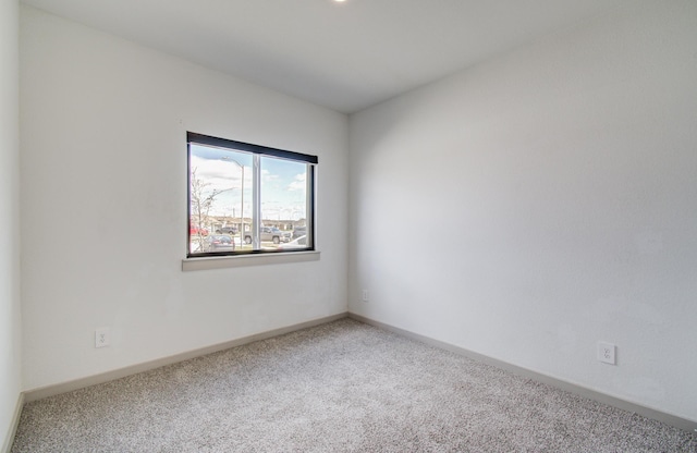 empty room with carpet and baseboards