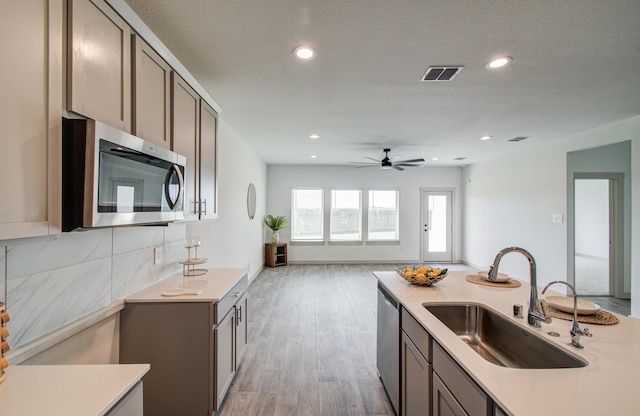 kitchen featuring a sink, light countertops, visible vents, and stainless steel appliances