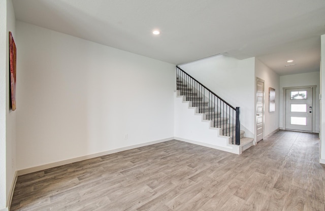 foyer with stairway, recessed lighting, light wood-type flooring, and baseboards