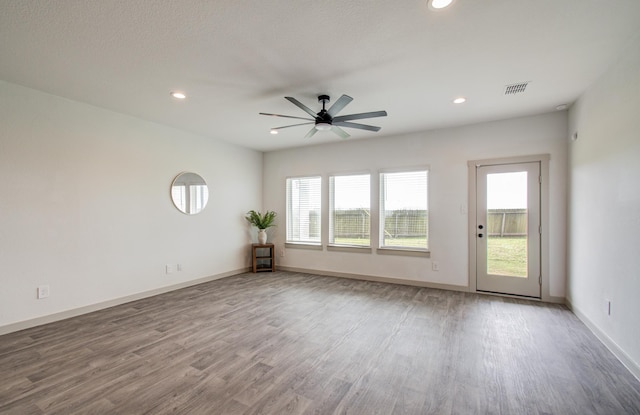 unfurnished room featuring recessed lighting, wood finished floors, visible vents, and ceiling fan