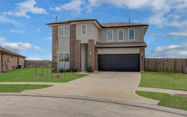 view of front of home with a front yard, fence, a garage, and stucco siding