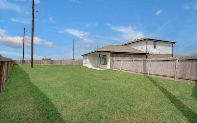 view of yard with a fenced backyard