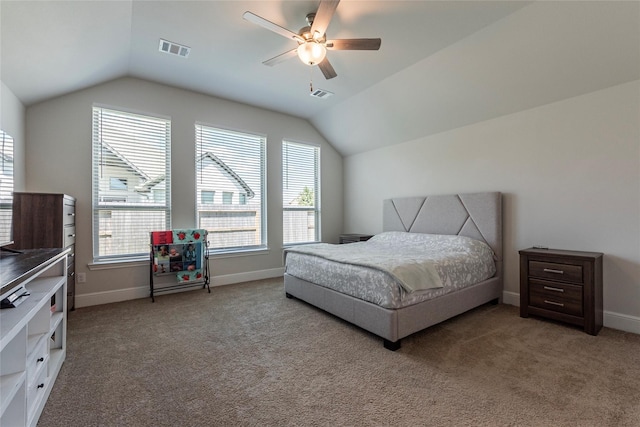 carpeted bedroom featuring visible vents, lofted ceiling, and multiple windows