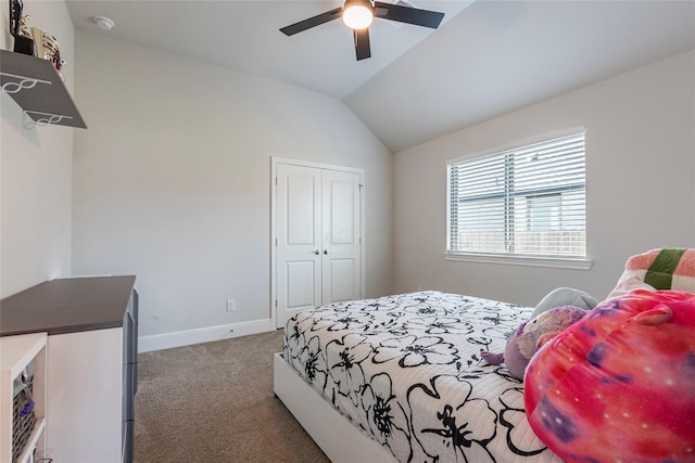 carpeted bedroom featuring baseboards, lofted ceiling, a closet, and a ceiling fan