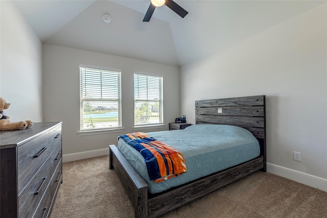 bedroom featuring vaulted ceiling, a ceiling fan, baseboards, and light carpet