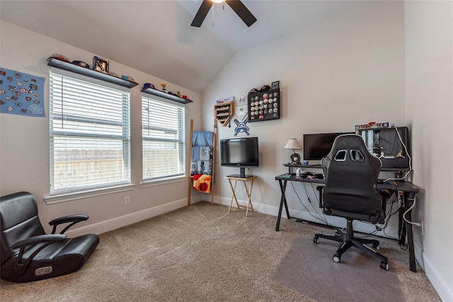 carpeted office space featuring baseboards, ceiling fan, and vaulted ceiling