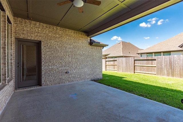 view of patio / terrace with fence and ceiling fan