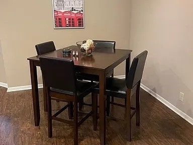 dining area featuring baseboards and wood finished floors