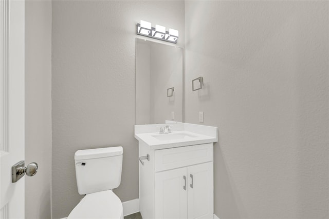 half bathroom with toilet and vanity