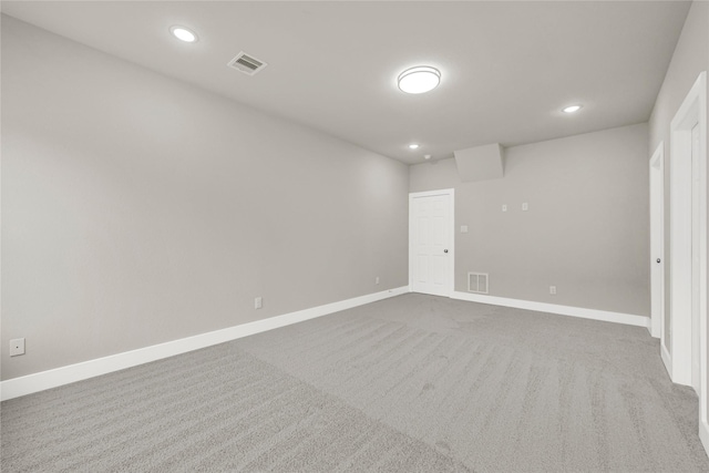 empty room with recessed lighting, baseboards, visible vents, and dark colored carpet