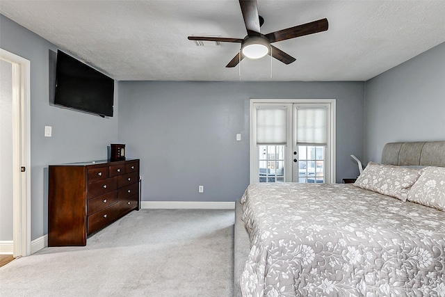 bedroom featuring baseboards, carpet, a ceiling fan, and a textured ceiling