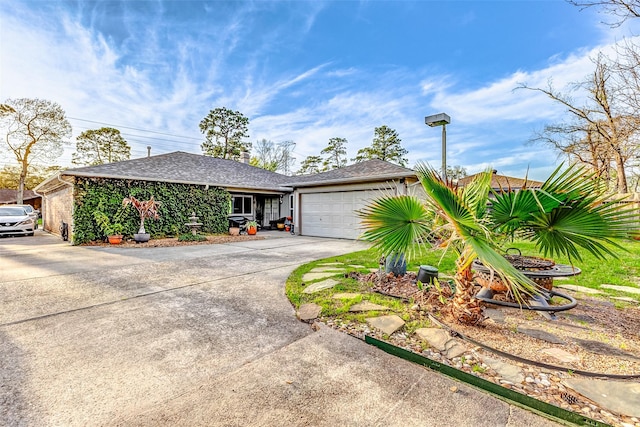 view of front of home featuring driveway, an attached garage, and roof with shingles