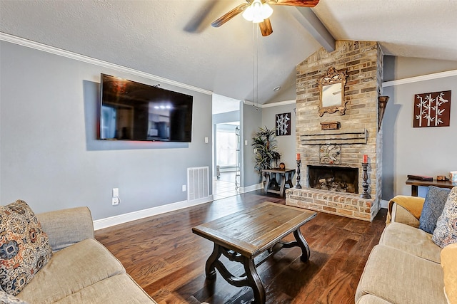 living area with wood finished floors, visible vents, vaulted ceiling with beams, ceiling fan, and a textured ceiling