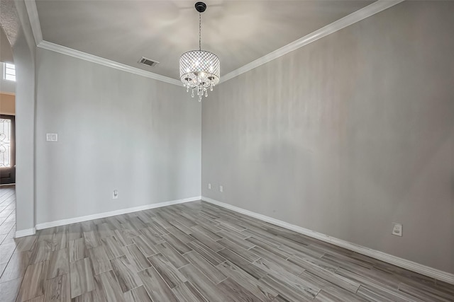 empty room featuring wood finished floors, visible vents, arched walkways, ornamental molding, and a notable chandelier