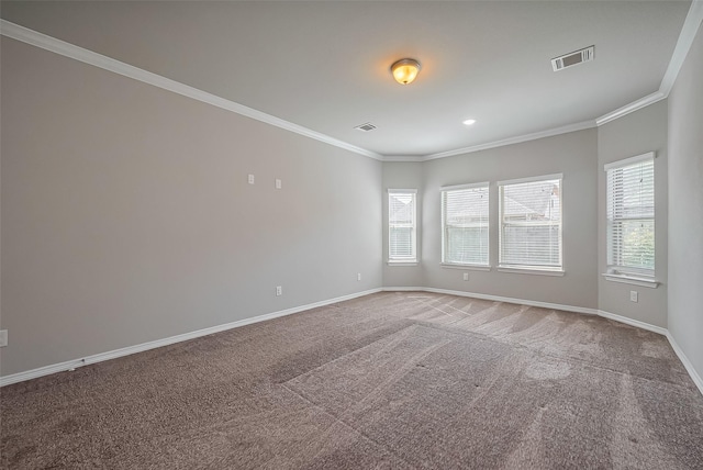 empty room featuring visible vents, baseboards, carpet floors, and ornamental molding