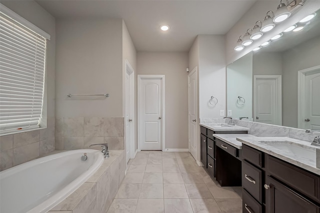 full bath with vanity, a bath, and tile patterned flooring