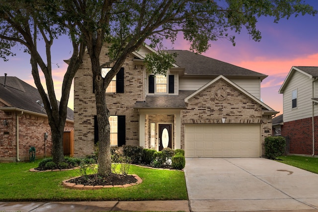 traditional-style house featuring brick siding, driveway, and a lawn