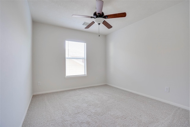 unfurnished room featuring baseboards, carpet floors, visible vents, and ceiling fan