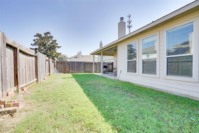 view of yard featuring a patio and a fenced backyard