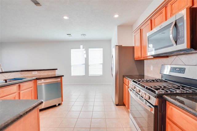 kitchen with light tile patterned floors, recessed lighting, backsplash, and stainless steel appliances