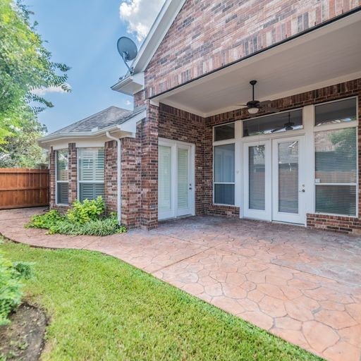 view of patio with ceiling fan and fence