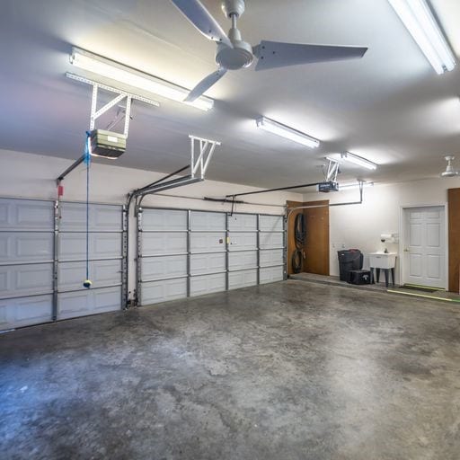 garage featuring a garage door opener and a sink