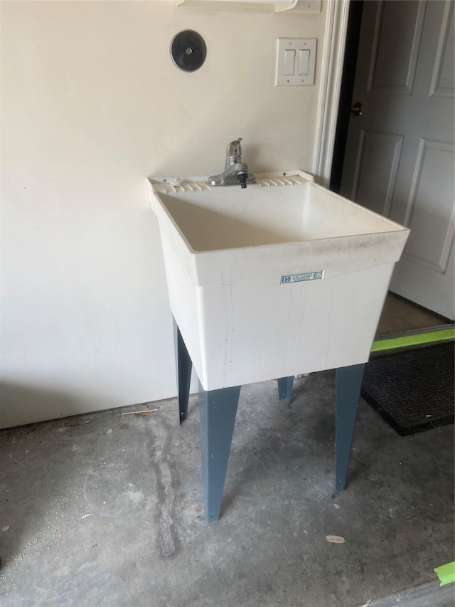 room details with unfinished concrete flooring and a sink