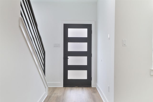 entrance foyer featuring baseboards and light wood-style floors