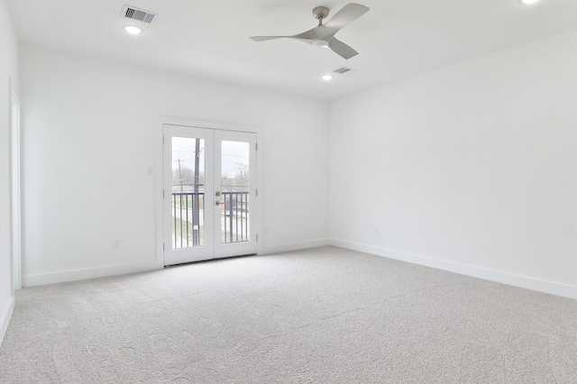 unfurnished room with baseboards, visible vents, carpet floors, ceiling fan, and french doors