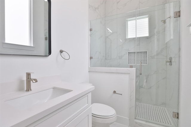 bathroom featuring toilet, vanity, and a marble finish shower
