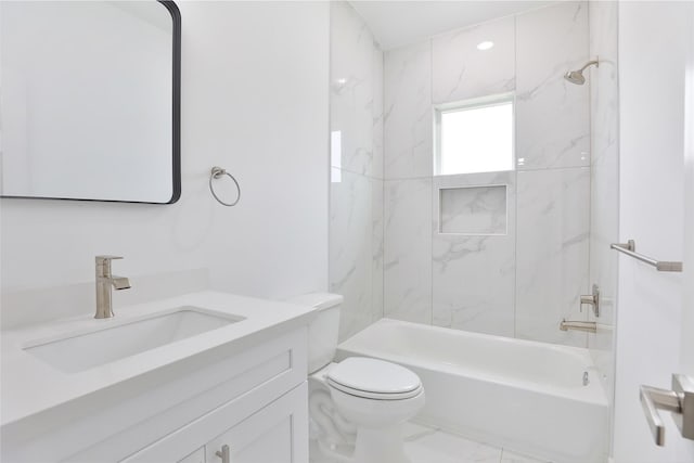 bathroom with vanity, toilet, marble finish floor, and bathing tub / shower combination