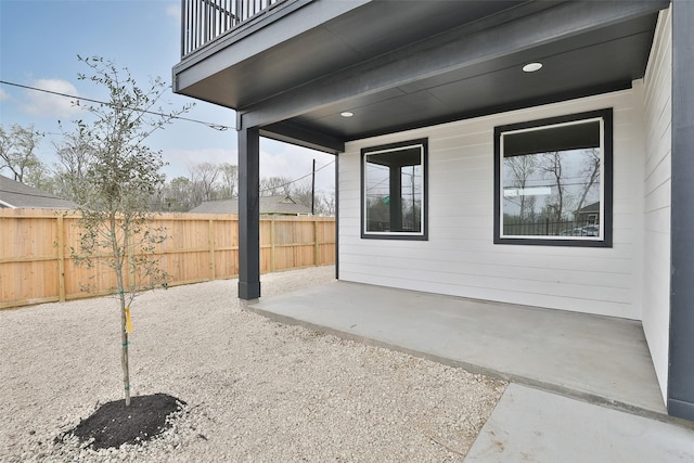 view of patio / terrace with a fenced backyard and a balcony